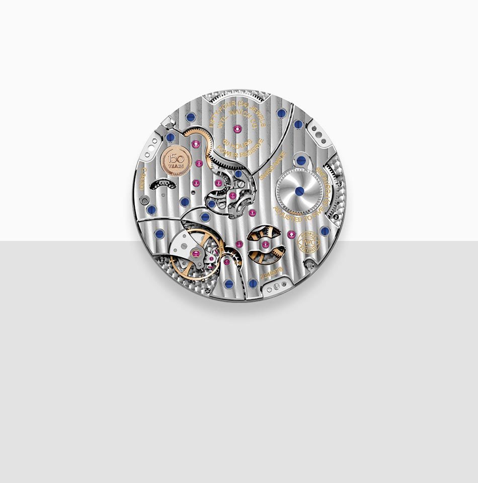 Juwelier-Morawitz-Uhrenlexikon-kaliber Dieses Bild zeigt eine Nahaufnahme eines Uhrwerkmechanismus von Juwelier Morawitz in Düsseldorf. Das komplizierte Design umfasst Zahnräder, Juwelen, Schrauben und andere Komponenten, die in einem kreisförmigen Muster angeordnet sind. Der Hintergrund ist horizontal geteilt, wobei die obere Hälfte weiß und die untere Hälfte hellgrau ist.