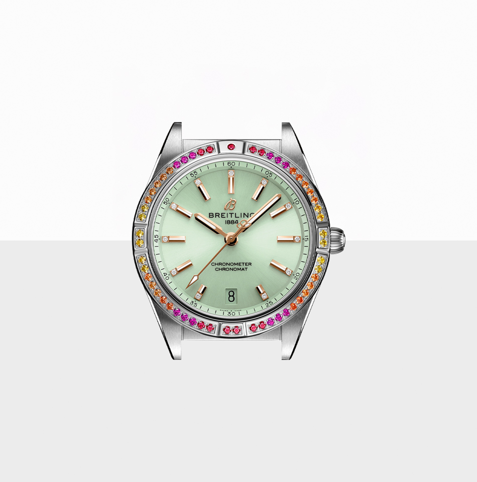 Juwelier-Morawitz-Uhrenlexikon-luenette-breitling Eine Breitling-Armbanduhr mit silbernem Metallgehäuse und hellgrünem Zifferblatt. Die Lünette ist mit mehrfarbigen Edelsteinen verziert. Die Uhr verfügt über roségoldene Stundenmarkierungen und Zeiger, eine Datumsanzeige auf der 6-Uhr-Position und das Breitling-Logo auf der 12-Uhr-Position. Erhältlich bei Juwelier Morawitz in Düsseldorf.