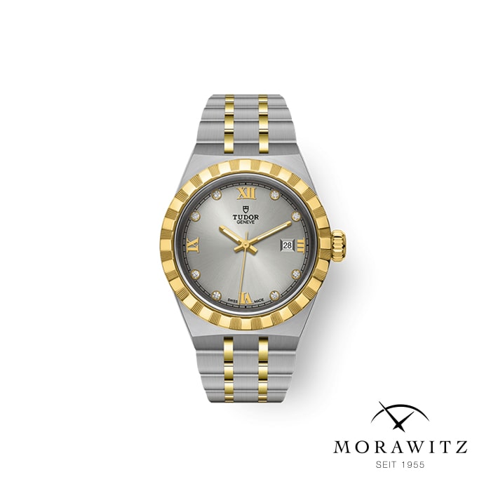 Eine luxuriöse zweifarbige Uhr mit einem silber-goldenen Armband. Das Zifferblatt ist silberfarben mit goldenen römischen Ziffern, diamantenen Stundenmarkierungen und einer Datumsanzeige auf der 3-Uhr-Position. Die Marke „Tudor“ ist zu sehen, und unten rechts steht „Morawitz Seit 1955“.