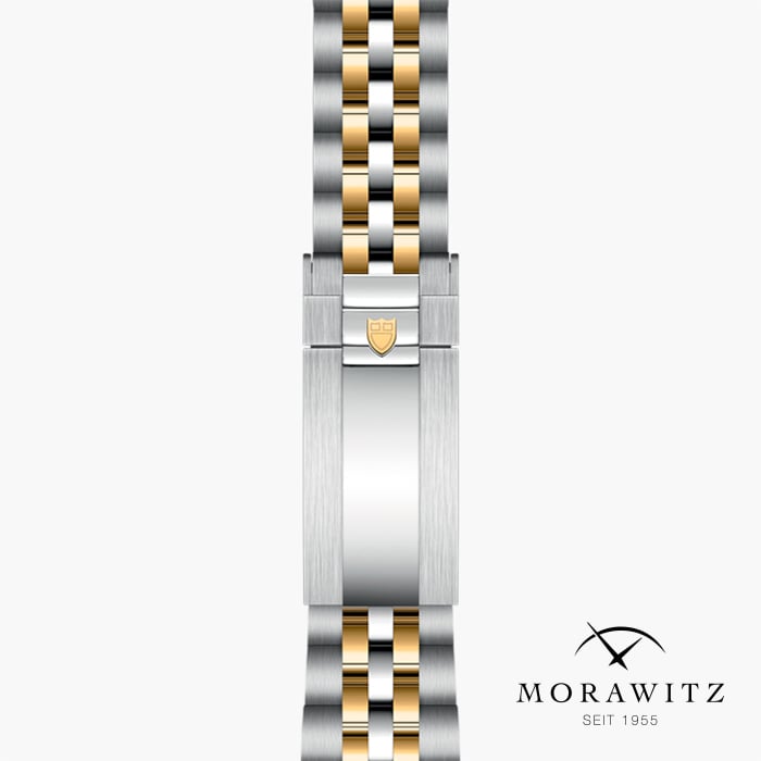 Ein luxuriöses Uhrenarmband von Morawitz mit einer eleganten Kombination aus silbernen und goldenen Gliedern und einer polierten Schließe. Das Morawitz-Logo und der Text „seit 1955“ werden in der unteren rechten Ecke auf weißem Hintergrund angezeigt.