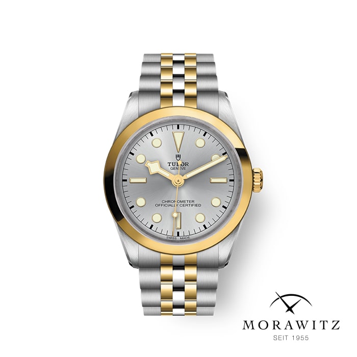 Eine zweifarbige Tudor-Armbanduhr in Silber und Gold mit einem grauen Zifferblatt mit goldenen Stundenmarkierungen und Zeigern. Die Uhr ist auf einem weißen Hintergrund mit dem „Morawitz“-Logo und dem Text „Seit 1955“ in der unteren rechten Ecke abgebildet.