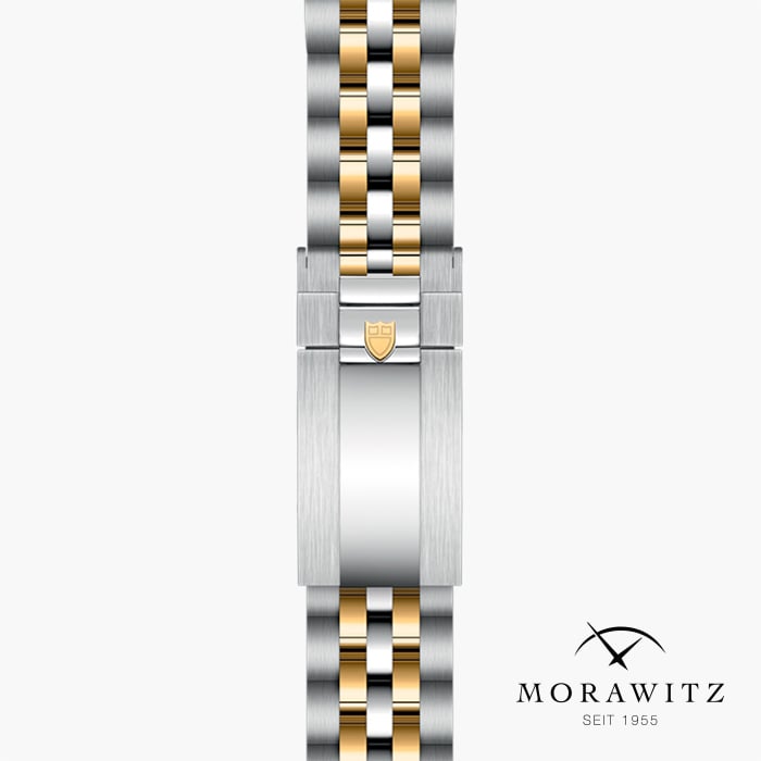 Ein detailliertes Bild eines Morawitz-Uhrenarmbands. Das Band besteht aus einer Kombination aus silberfarbenen und goldfarbenen Metallgliedern, was ihm einen raffinierten zweifarbigen Look verleiht. Das Logo und der Text „SEIT 1955“ sind in der unteren rechten Ecke sichtbar.