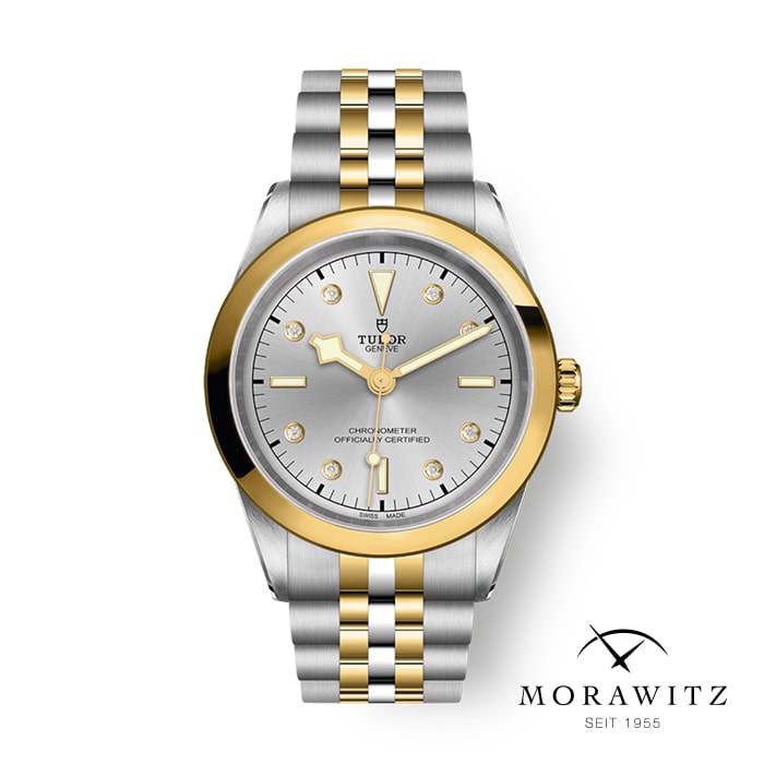 Eine luxuriöse Tudor-Armbanduhr mit einem zweifarbigen Armband aus Silber und Gold und einem silbernen Zifferblatt mit goldenen Akzenten. Das Zifferblatt enthält das Tudor-Logo, den Text „OYSTERPRINCE TUDOR GENEVE“ und Angaben zur Chronometer-Zertifizierung. Unten rechts steht „MORAWITZ SEIT 1955“.